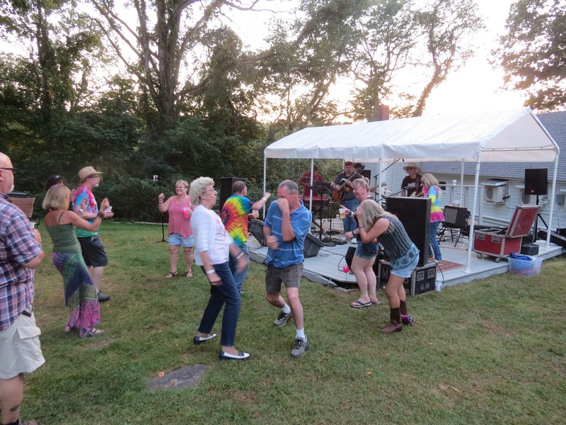 Band performing with crowd dancing in front
